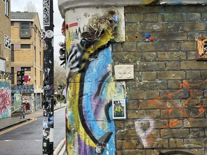 A 5=3 plaque on a wall of London street art