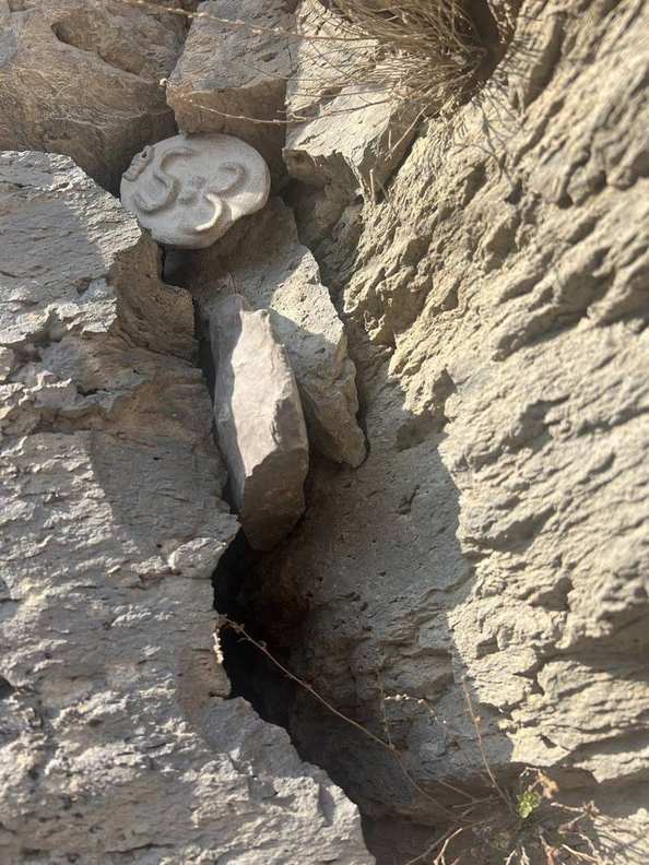 A 5=3 ceramic plaque wedged into the basalt columns at Garni, Armenia